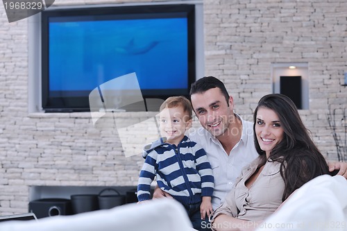 Image of happy young family have fun  with tv in backgrund