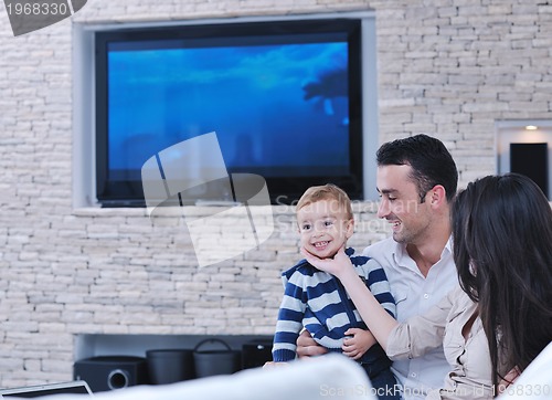 Image of happy young family have fun  with tv in backgrund