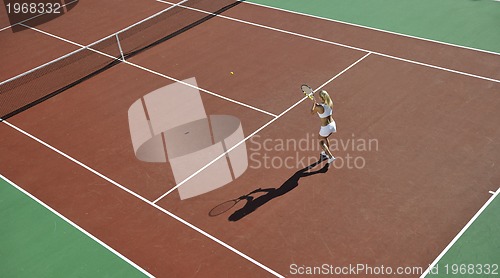 Image of young woman play tennis outdoor