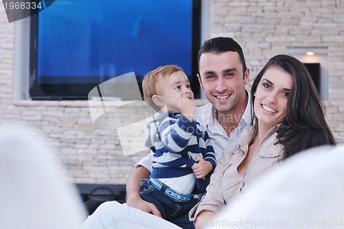 Image of happy young family have fun  with tv in backgrund