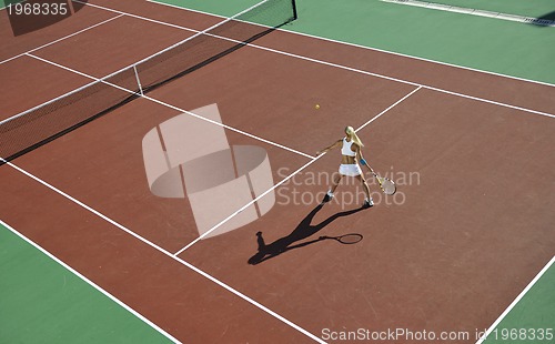 Image of young woman play tennis outdoor