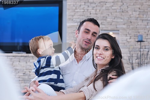 Image of happy young family have fun  with tv in backgrund