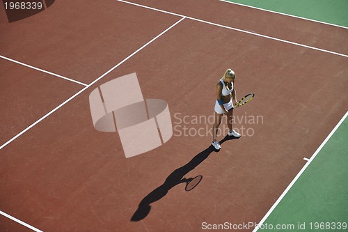 Image of young woman play tennis outdoor