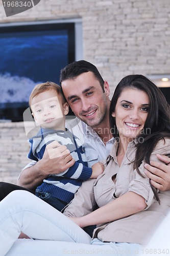 Image of happy young family have fun  with tv in backgrund