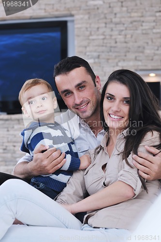 Image of happy young family have fun  with tv in backgrund