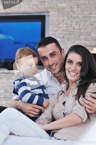 Image of happy young family have fun  with tv in backgrund