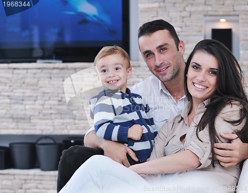 Image of happy young family have fun  with tv in backgrund