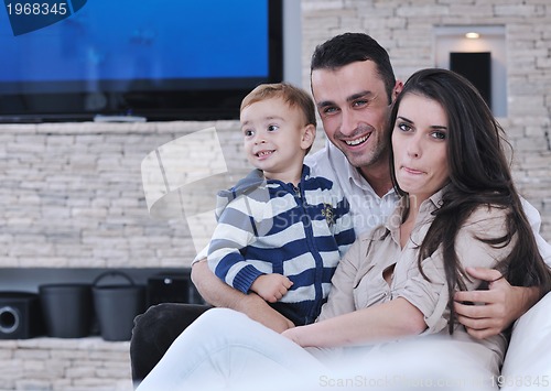 Image of happy young family have fun  with tv in backgrund