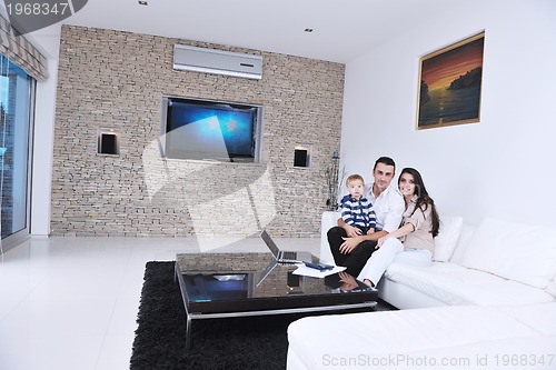 Image of happy young family have fun  with tv in backgrund