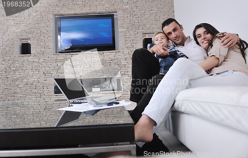 Image of happy young family have fun  with tv in backgrund