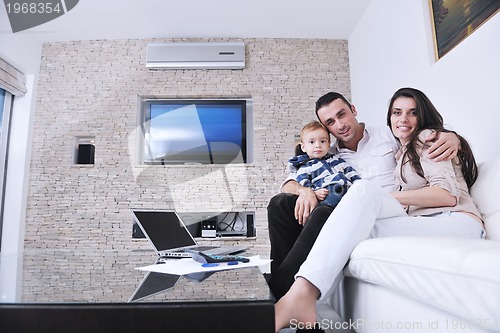 Image of happy young family have fun  with tv in backgrund