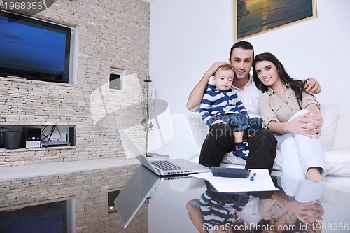 Image of happy young family have fun  with tv in backgrund