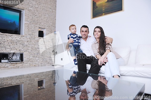 Image of happy young family have fun  with tv in backgrund