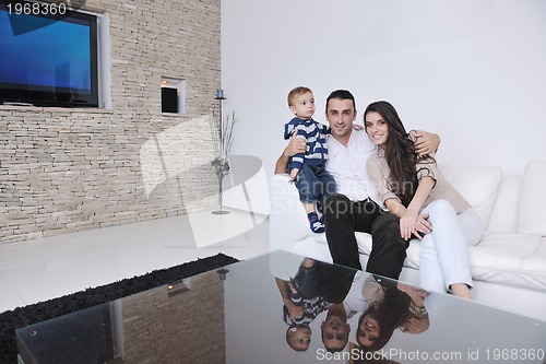 Image of happy young family have fun  with tv in backgrund