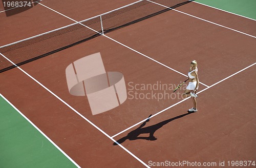 Image of young woman play tennis outdoor