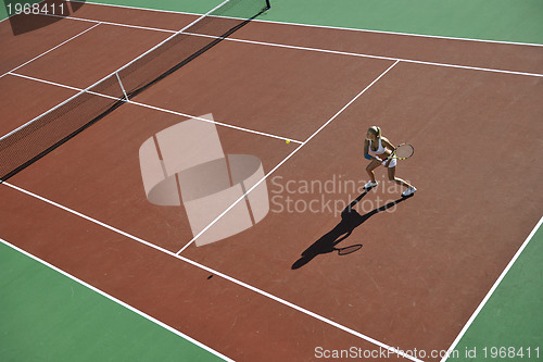 Image of young woman play tennis outdoor