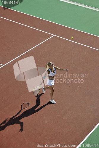 Image of young woman play tennis outdoor