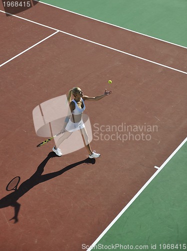 Image of young woman play tennis outdoor