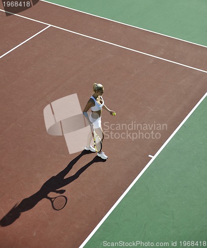 Image of young woman play tennis outdoor