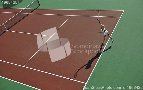 Image of young woman play tennis outdoor