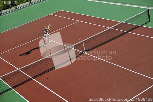 Image of young woman play tennis outdoor
