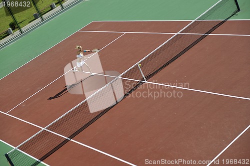 Image of young woman play tennis outdoor