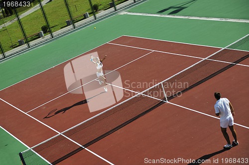 Image of happy young couple play tennis game outdoor