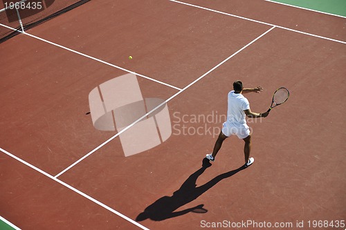 Image of young man play tennis