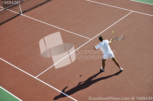 Image of young man play tennis