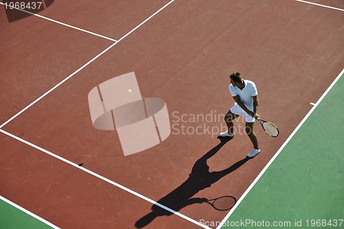 Image of young man play tennis