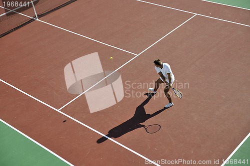 Image of young man play tennis