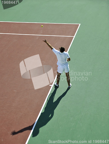 Image of young man play tennis