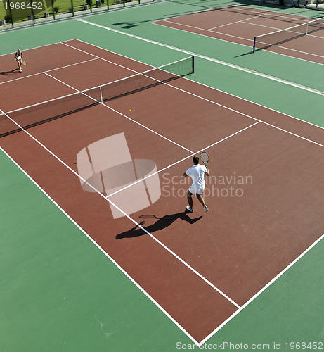 Image of happy young couple play tennis game outdoor