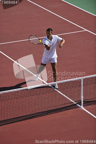 Image of young man play tennis outdoor