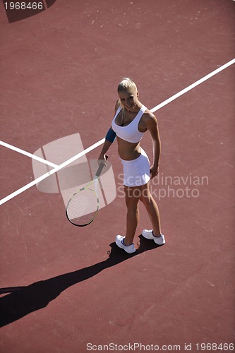 Image of young woman play tennis outdoor