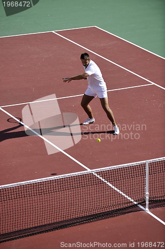 Image of young man play tennis