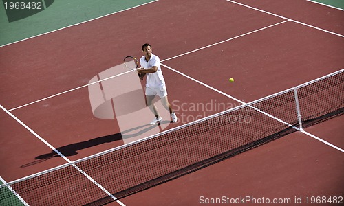 Image of young man play tennis