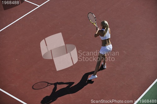 Image of young woman play tennis outdoor