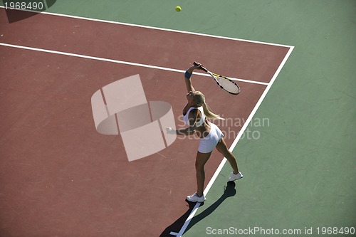 Image of young woman play tennis outdoor