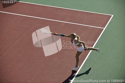 Image of young woman play tennis outdoor