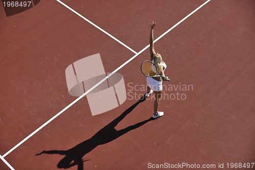 Image of young woman play tennis outdoor