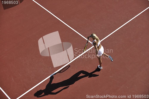 Image of young woman play tennis outdoor