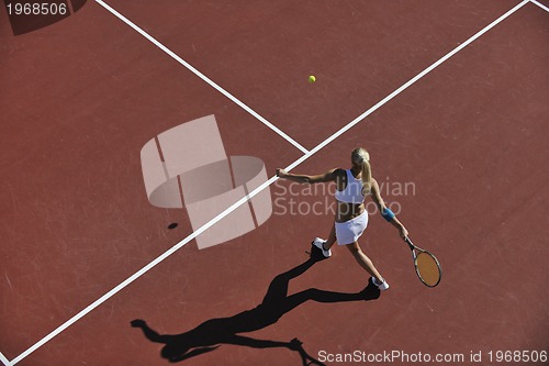 Image of young woman play tennis outdoor