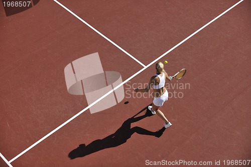 Image of young woman play tennis outdoor