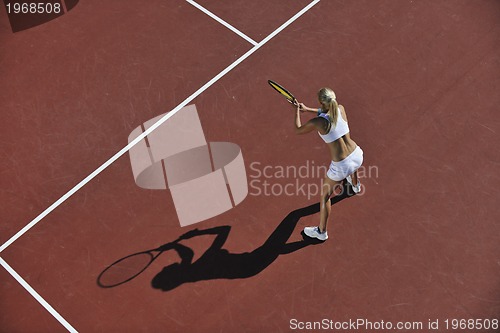 Image of young woman play tennis outdoor