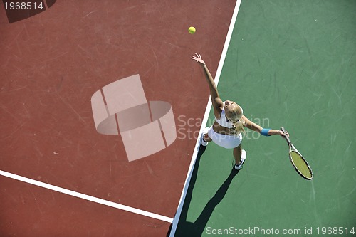 Image of young woman play tennis outdoor