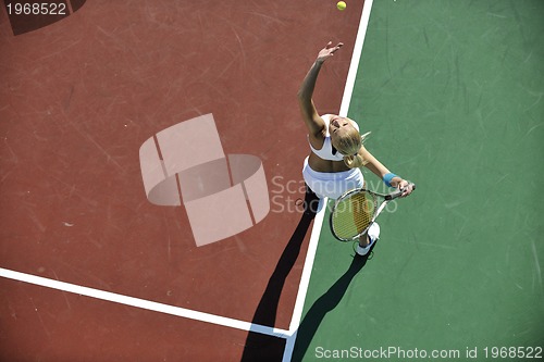 Image of young woman play tennis outdoor