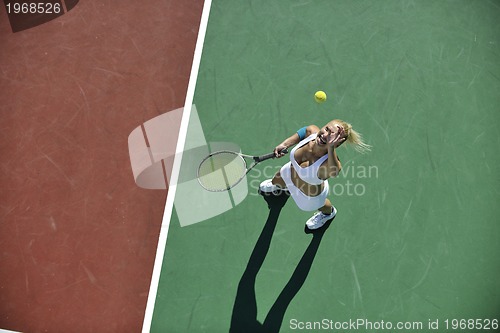 Image of young woman play tennis outdoor