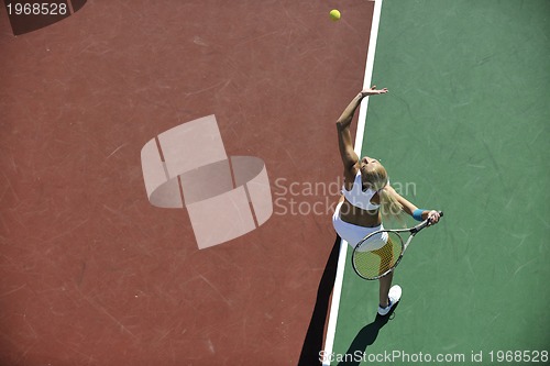 Image of young woman play tennis outdoor