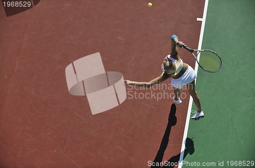 Image of young woman play tennis outdoor
